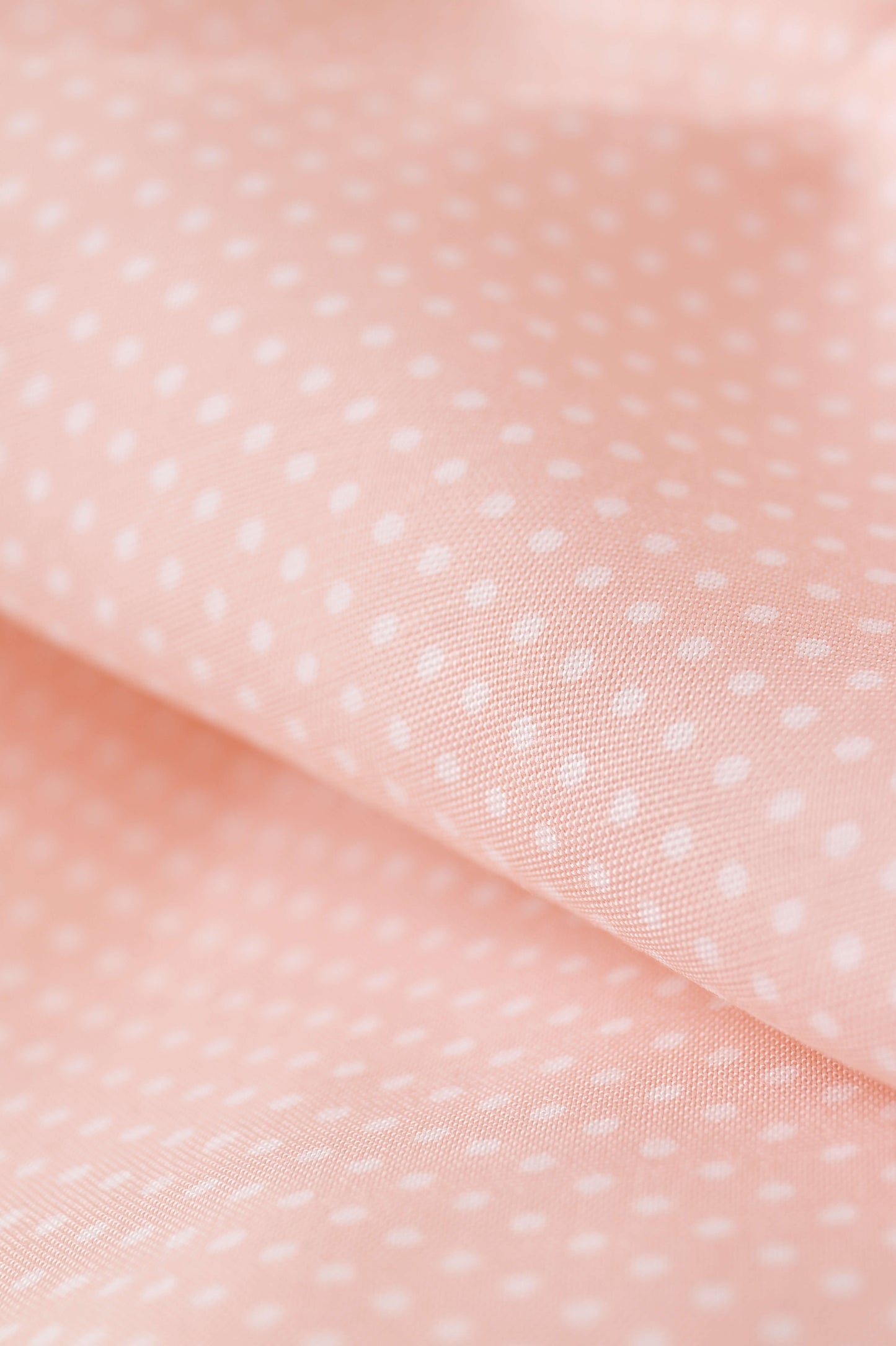 Popeline de viscose rose pêche à pois blancs