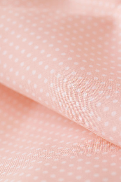Popeline de viscose rose pêche à pois blancs