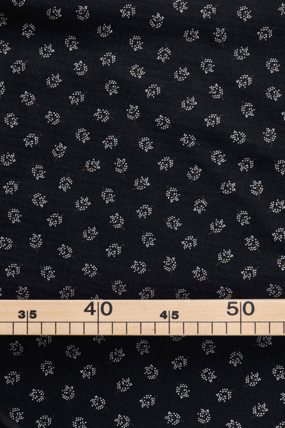 tissu pour couture bébé ou femme 
double gaze de coton biologique noire imprimée motif feuillage blanc/écru/marron